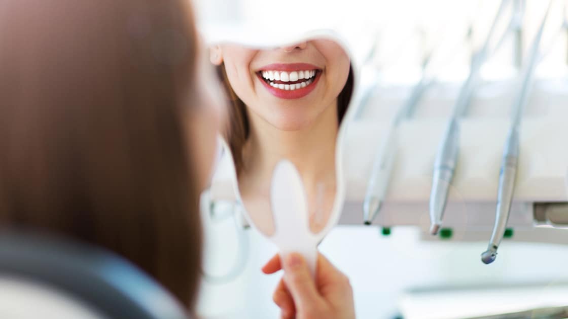 Smiling Patient Looking in Mirror