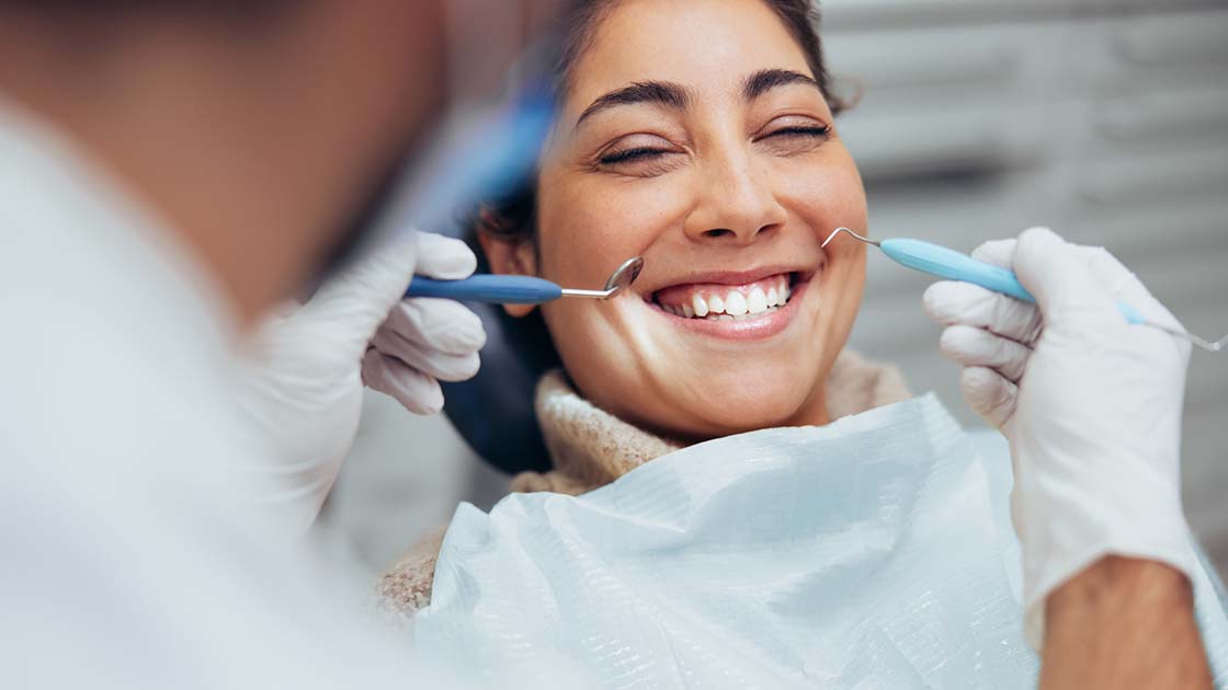 Woman Smiling in Dental Chair