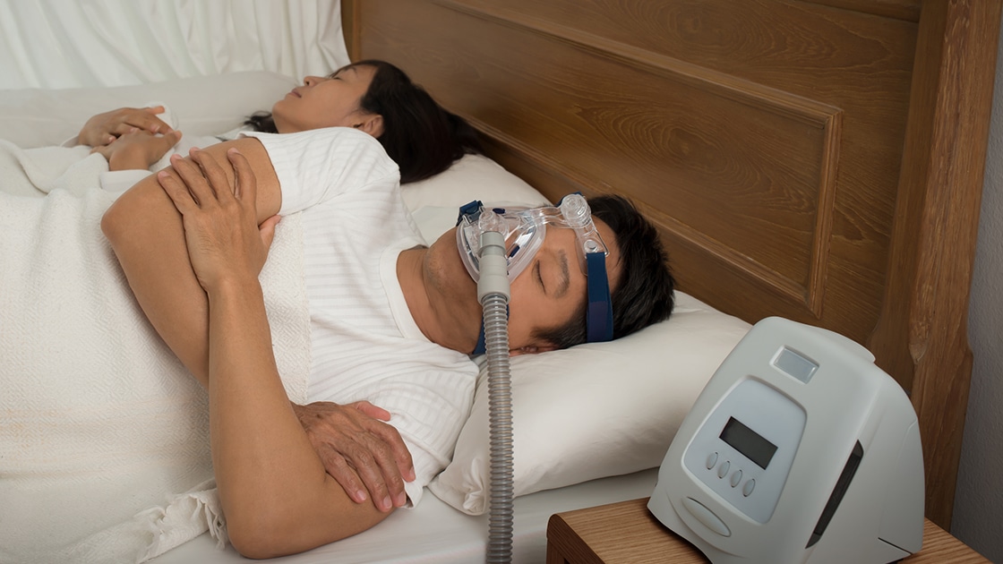 Sleeping man with CPAP